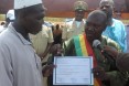 The Mayor of Sio hands out certificate to the village chief