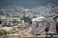 A Haitian man washes outside of an emergency shelter in Port-au-Prince, Haiti 