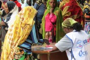 USAID works with a number of non-governmental organization partners to support the Productive Safety Net Program in Ethiopia. Here a worker for USAID-partner Catholic Relief Services helps to organize distributions.  
