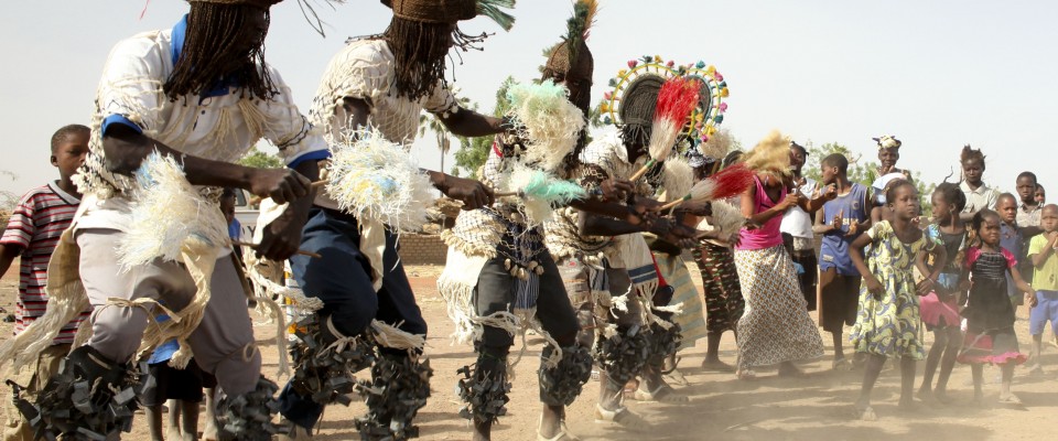 Traditional Bobo dancers greet USAID/Mali partners in Segou region.