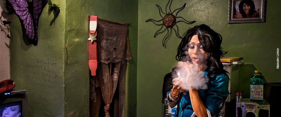A transgender person smokes in her room in Mexico