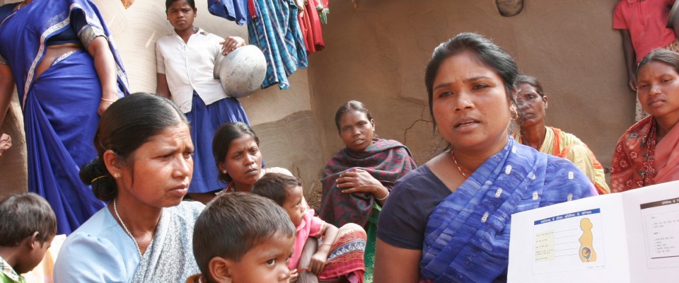 A USAID-supported health worker discusses reproductive health with village women in the state of Uttar Pradesh.