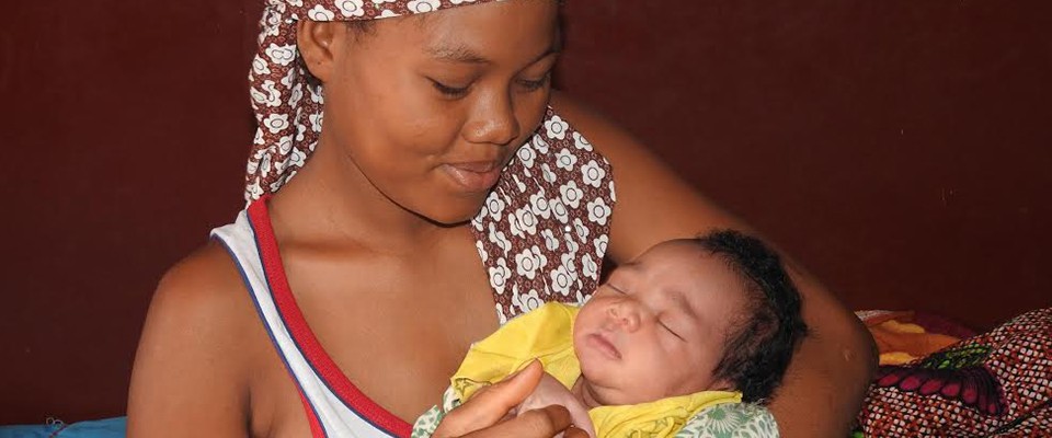 A happy mother with her baby after a safe delivery in a health center.