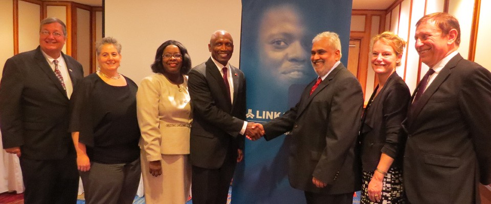 US Ambassador to Trinidad and Tobago John L. Estrada greets Trinidad's Chief Medical Officer Dr. Akenath Misir.
