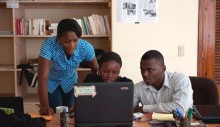 ENDK journalist Witza Petit Antoine is flanked by Internews researchers Louisena Louis, left, and Franck Lafont as they sort SMS