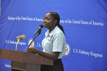 Tennesha Rhule conveys her story to members of the U.S. Embassy community at an HIV forum in 2012.