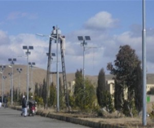 Technicians install LED lamps and solar panels for streetlights at Shaikh Zahed University.