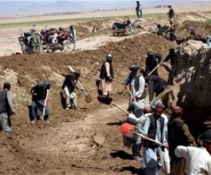 A team of laborers cleans a canal in Daman District, Kandahar.