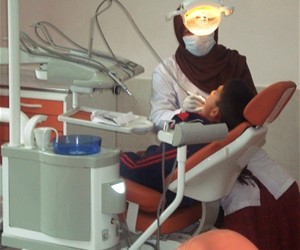 A dentist at Kabul Medical University’s Dentistry Teaching Clinic treats a young patient in the pediatrics department.