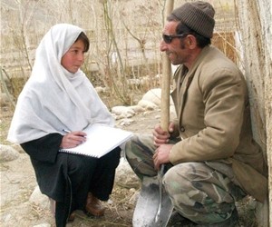 Twelve-year-old Seema interviews a local Wakhan farmer for a USAID-funded survey on livestock mortality. She is a member of one 