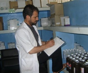 Pharmacist Zakhi Ahmad Qiami records medicines on a stock card in the pharmacy at the Indira Gandhi Children’s Hospital in Kabul