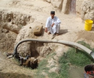 Abdul Manan and the water pump provided to him by USAID’s ACAP program.