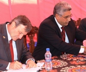 U.S. Ambassador Karl W. Eikenberry (left), Minister of Agriculture Mohammad Asif Rahimi (center), and USAID Acting Mission Direc