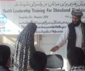 Shindand District Governor, Lal Mohammad Omarzai hands out certificate during the closing ceremony in October 2010.