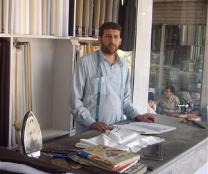 A young man learns how to run a tailoring business as part of an apprenticeship program for day laborers in Jalalabad.