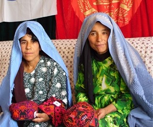 Members of the silkworm production display their silk-embroidered products.