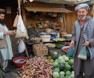 Baharak Bazaar vegetable trader Faiz Mohammad (left) has enjoyed brisk sales since the completion of USAID’s road building campa
