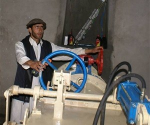A technician switches on the Dodarak Micro-Hydropower Plant for the first time.`