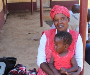 Setsabile and her baby Njabulo wait to receive food assistance through USAID partner World Vision.