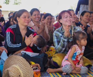 Villagers in Nakhayom applaud at an event to distribute long-lasting, insecticide treated nets.