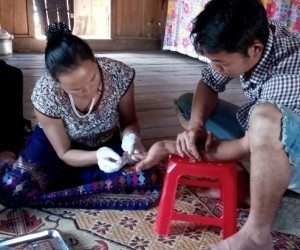 HIV testing being provided in a rural Vietnamese home by a lay provider.