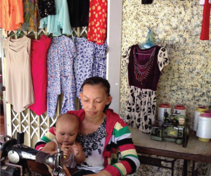 Pham Ngoc Yen repairs clothes in her shop.
