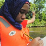 An ASEAN youth volunteer records the impact of pollution on a Malaysian river ecosystem.