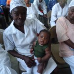 Tilma, a traditional birth attendant in rural Haiti, holds a healthy baby boy delivered by one of her patients. 