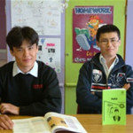 Ali and Hussain Saberi, with Dari textbooks published by USAID.