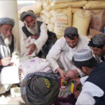 Afghan farmers cash in seed and fertilizer vouchers as part of a USAID-assisted poppy eradication program.