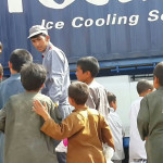 Excited children mill around the Badghis Ice Production Factory the day it opened