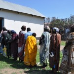 Program participants stand in line to receive a cash transfer for food outside a training facility in Juba, South Sudan