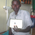 Diogene displays his insurance card at the health clinic.
