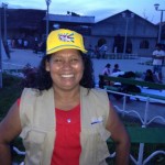Maria Tereza Sangama wears a hat bearing the campaign slogan: Pure Collective Energy!