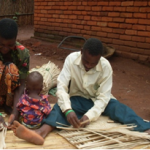 Photo of Malawian woman and man weaving baskets together