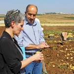 A Palestinian farmer explains to USAID's Mara Rudman the difference between regular potatoes and those grown for Al Salam