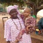 Community Health Worker Holds Baby