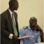 A court officer and a police officer discusses in an office