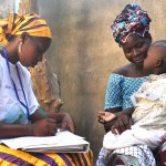Community health worker tests 2-year-old boy for malaria in Mali.