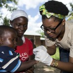 Neema Shosho, nutritionist, takes a blood sample from a child in Tanzania.