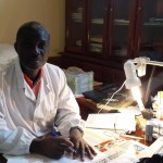 Dr. Anwanzi Ahui working at a desk