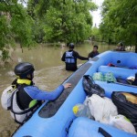 Rafters wade in waist-deep waters to rescue victims of flooding in Bosnia and Herzegovina.