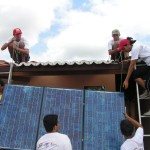Youth learn how to install solar panels to power a computer center in the rural community of São João. 