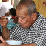 A man eating soup at an assistance center