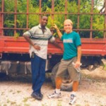 Partners Farmer to Farmer volunteer Norman Bezona and local coordinator Benito Jasmin transport bamboo plants in northern Haiti.