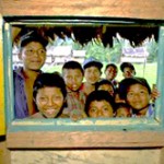 Indigenous children peer through a window at the Bosawas Biosphere Reserve.