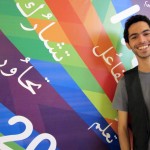 Al Zaghal stands beside his winning poster