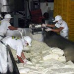Employees process cheese at Agroindustrias San Julian plant.