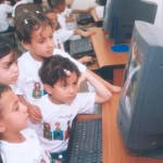 Children are captivated by the educational software program at a knowledge station in Madaba, a town south of Amman, Jordan. 