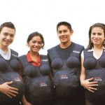 Young women and men in Guatemala try on “pregnancy suits” as part of reproductive health training for youth